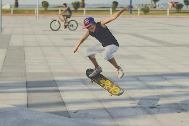 Kid skating away from a ramp.